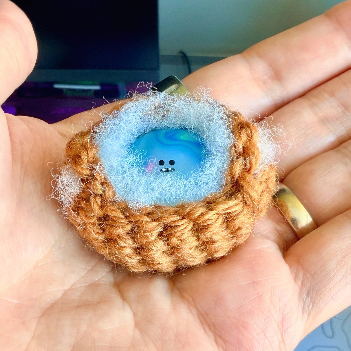 A handmade special edition Bonino - 90s water elemental swirl design - sitting in handmade crochet basket.